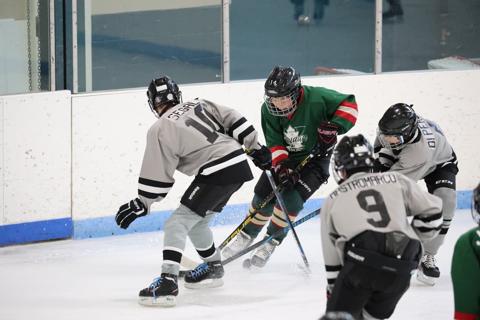 Youth hockey players battling for the puck at a Vaughan arena